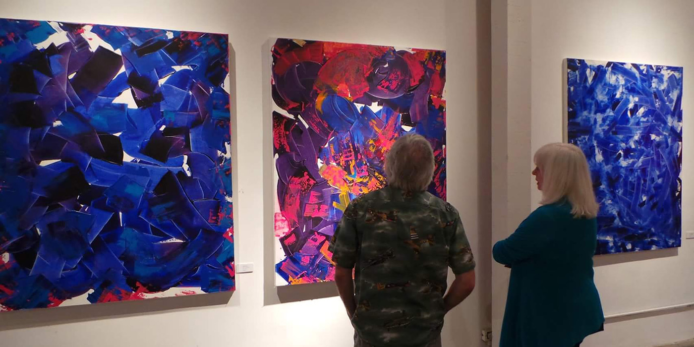 Couple enjoying colorful paintings