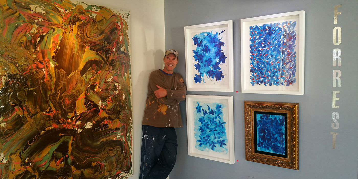 Artist scott forrest with his paintings