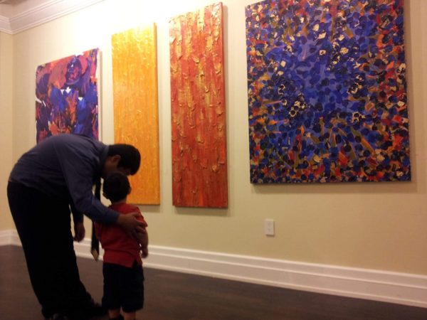 Father showing his son paintings by Abstract Artist Scott Forrest